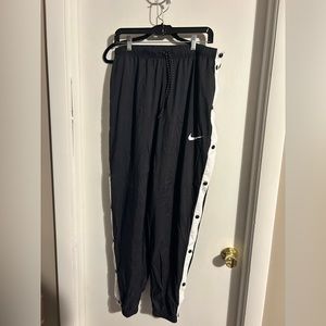 Black parachute pants with buttons on side